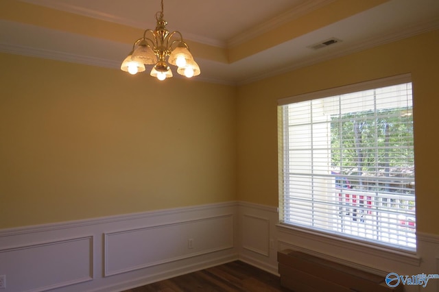 empty room featuring a notable chandelier, crown molding, and dark wood-type flooring