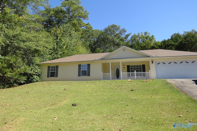 ranch-style house featuring a garage, a front lawn, and covered porch