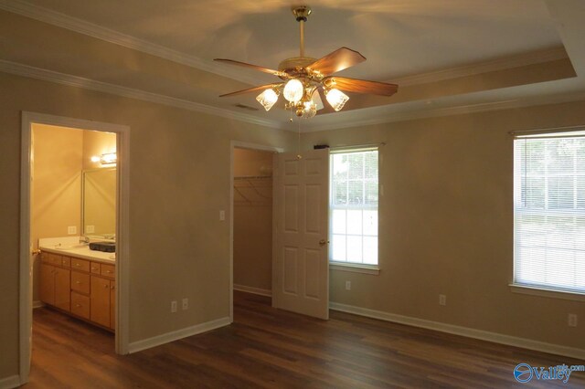 bedroom with ceiling fan, ensuite bathroom, dark hardwood / wood-style flooring, and multiple windows