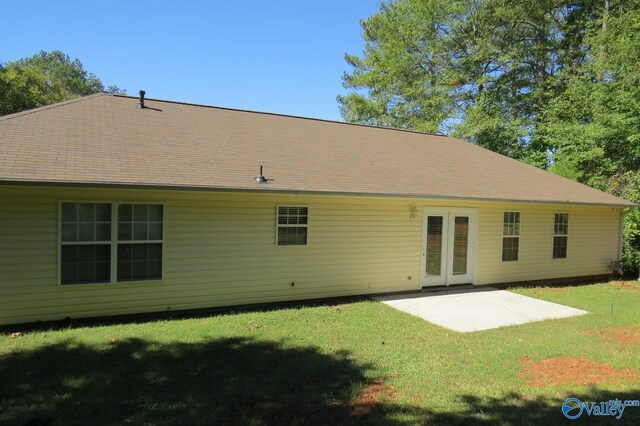 rear view of property with a lawn and a patio