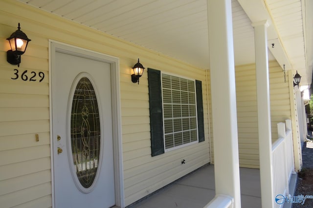 view of exterior entry featuring a porch