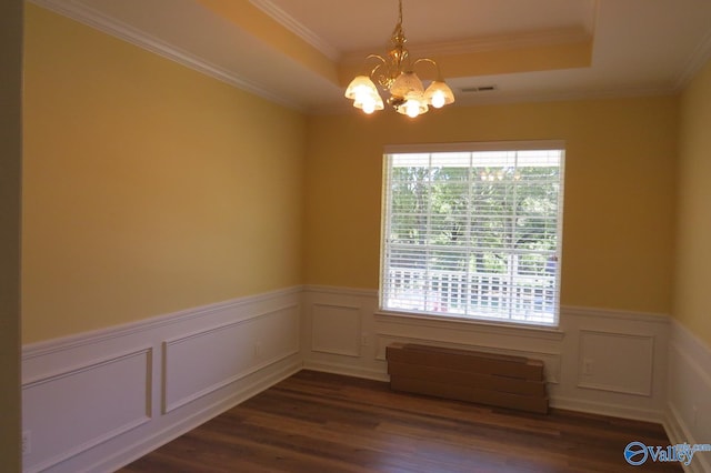 empty room with a notable chandelier, crown molding, dark hardwood / wood-style flooring, and a wealth of natural light