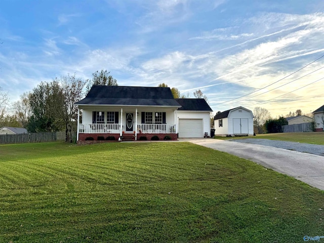 ranch-style house with a yard, covered porch, a garage, and a storage unit