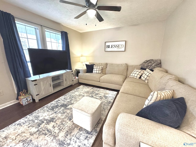 living room featuring a textured ceiling, ceiling fan, and dark hardwood / wood-style floors