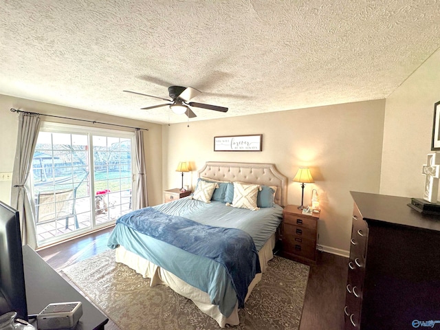 bedroom featuring access to exterior, ceiling fan, dark hardwood / wood-style flooring, and a textured ceiling