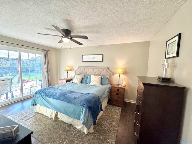 bedroom with dark hardwood / wood-style floors, ceiling fan, a textured ceiling, and access to outside