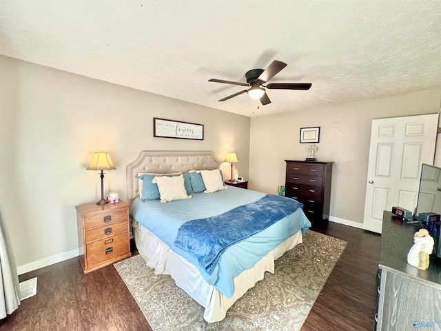 bedroom featuring ceiling fan, dark hardwood / wood-style flooring, and a textured ceiling