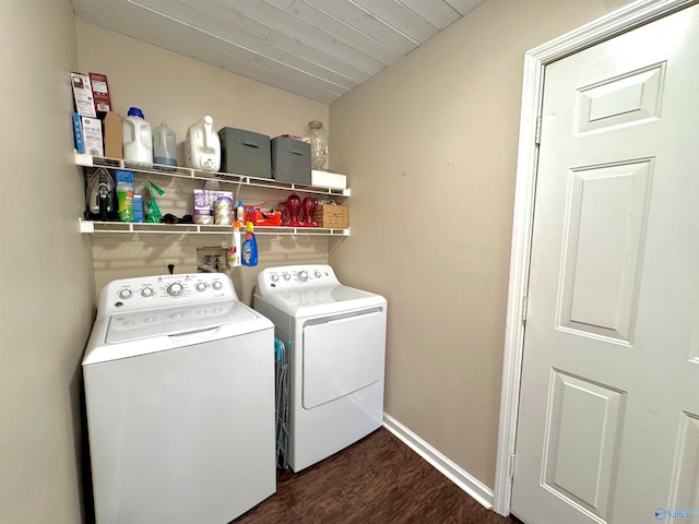 clothes washing area with washing machine and dryer and dark hardwood / wood-style floors