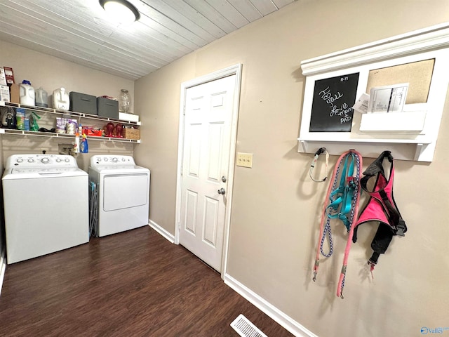 clothes washing area featuring washer and dryer and dark hardwood / wood-style flooring