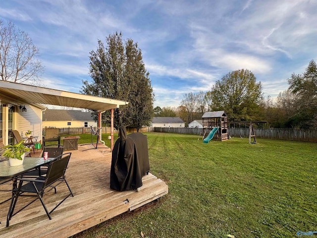 view of yard featuring a playground and a deck