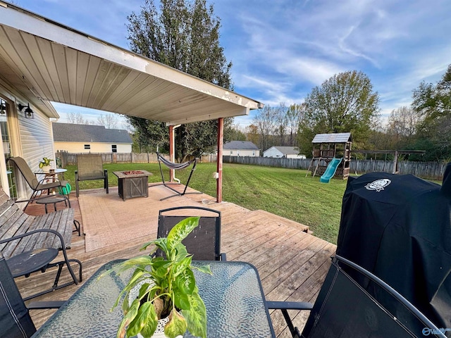 view of patio featuring area for grilling, a deck, a playground, and an outdoor fire pit