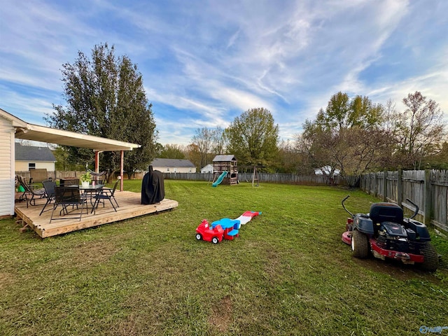 view of yard featuring a playground and a deck