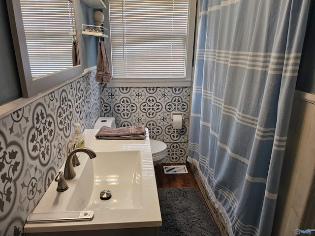 bathroom featuring hardwood / wood-style floors, vanity, and toilet