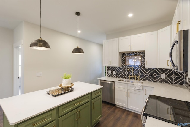 kitchen with sink, white cabinetry, green cabinetry, hanging light fixtures, and stainless steel appliances