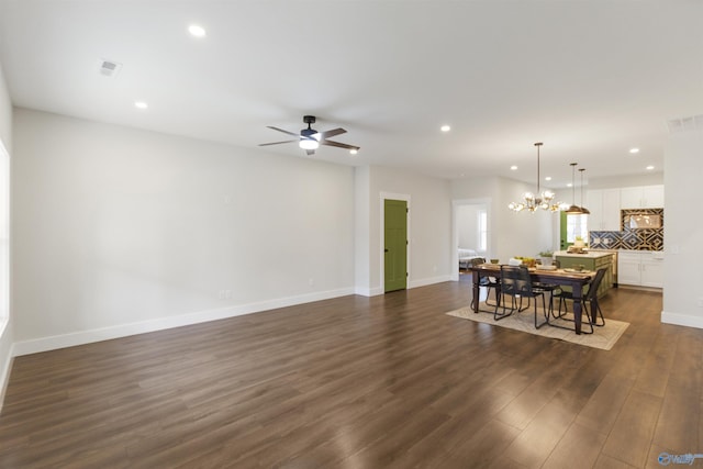 dining room featuring dark wood-type flooring and ceiling fan with notable chandelier