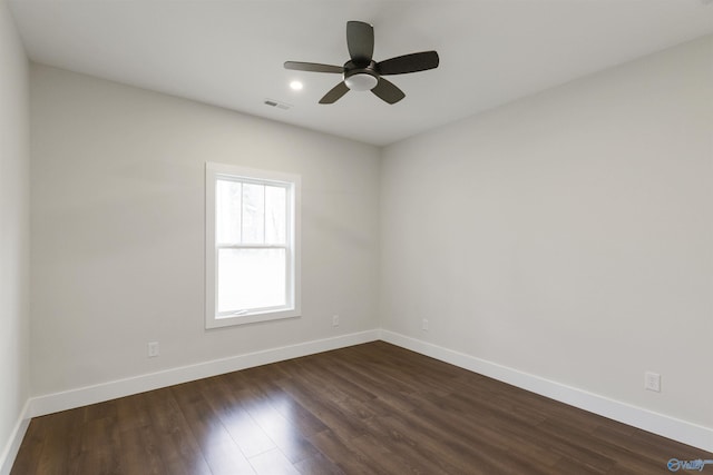 empty room with dark hardwood / wood-style floors and ceiling fan