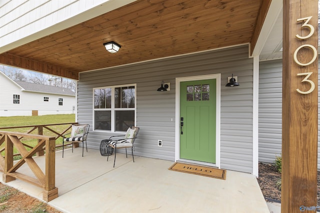 doorway to property featuring covered porch