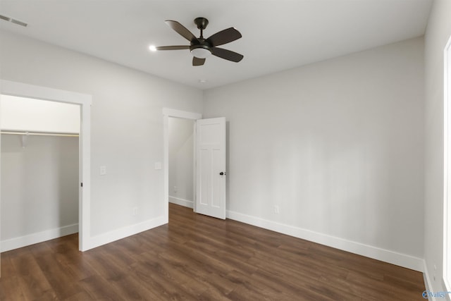 unfurnished bedroom featuring dark wood-type flooring, ceiling fan, and a closet