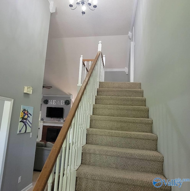2340 Pine Lake Trl, Arab, AL 35016 - stairway featuring an inviting chandelier, baseboards, and a fireplace