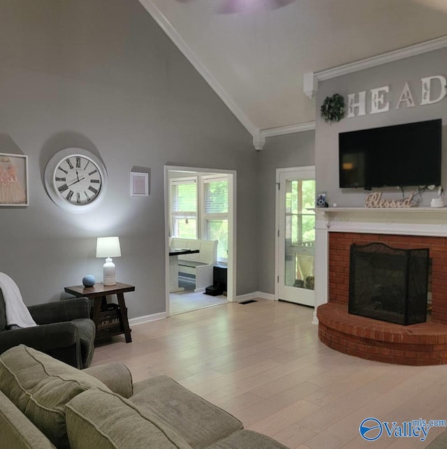 2340 Pine Lake Trl, Arab, AL 35016 - living area featuring baseboards, ornamental molding, a brick fireplace, and light wood-type flooring