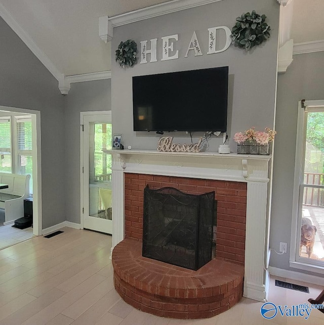 2340 Pine Lake Trl, Arab, AL 35016 - living area with crown molding, baseboards, a fireplace, and visible vents