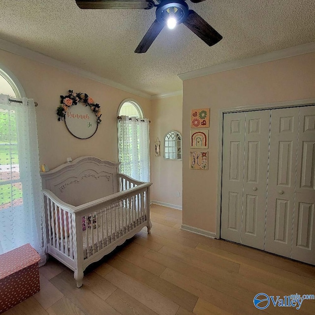 2340 Pine Lake Trl, Arab, AL 35016 - bedroom featuring ornamental molding, multiple windows, a textured ceiling, and wood finished floors