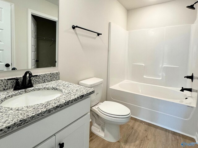 full bathroom featuring vanity, toilet, bathtub / shower combination, and wood-type flooring