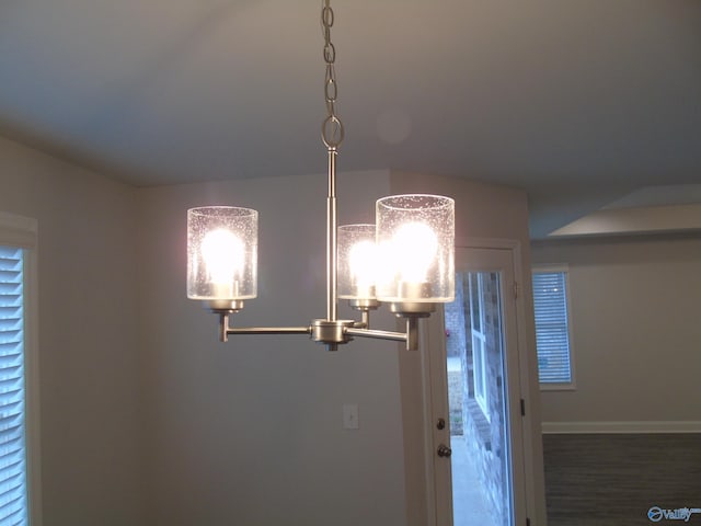 interior details with baseboards and wood finished floors