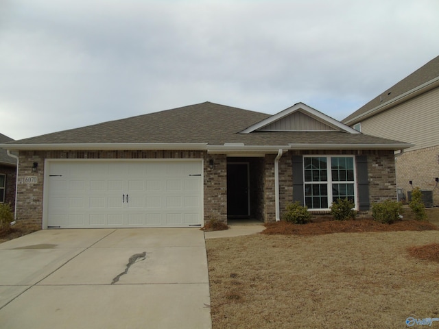 single story home featuring a garage, brick siding, roof with shingles, and concrete driveway