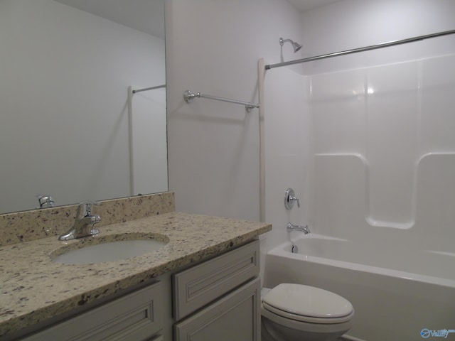 full bath featuring toilet, vanity, and shower / tub combination