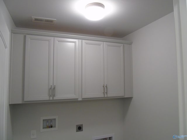 clothes washing area with visible vents, cabinet space, hookup for an electric dryer, and washer hookup