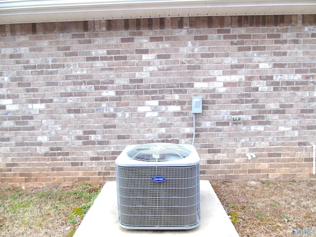 exterior details with brick siding and central AC