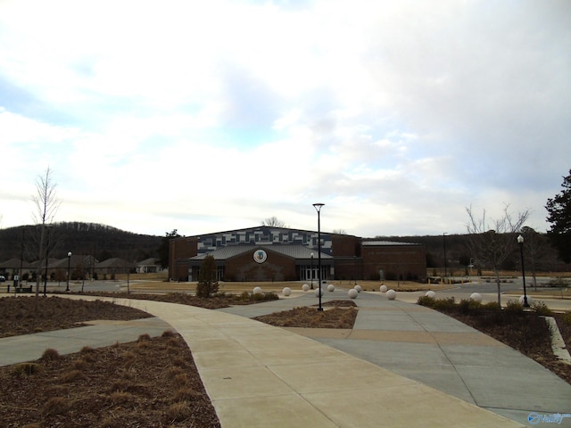 view of community featuring concrete driveway