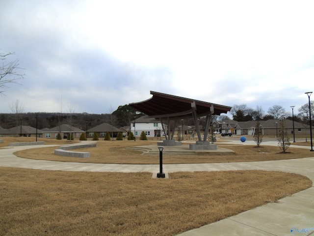 view of property's community featuring a yard and a residential view