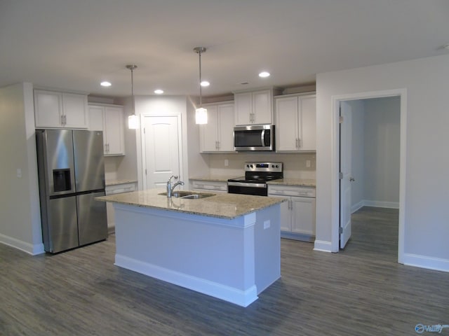 kitchen featuring appliances with stainless steel finishes, white cabinetry, and a sink