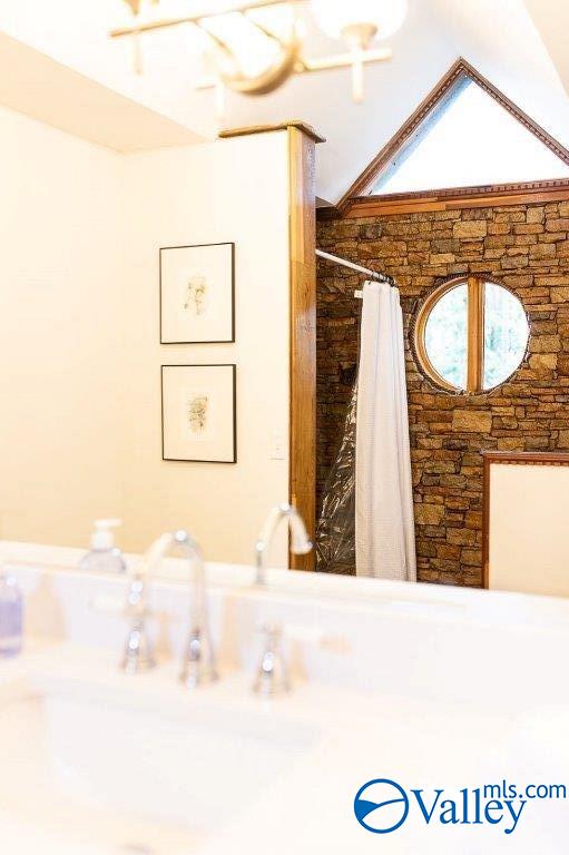 bathroom featuring vaulted ceiling