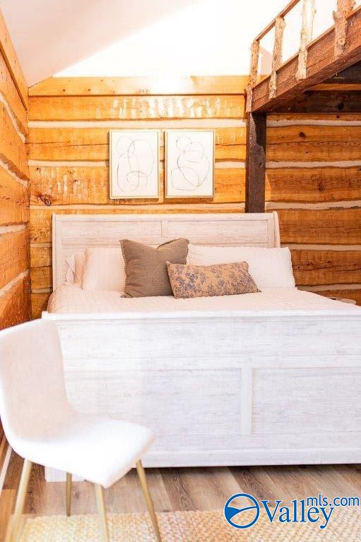 bedroom with hardwood / wood-style flooring and vaulted ceiling