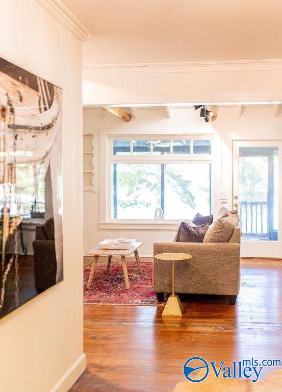 interior space with hardwood / wood-style flooring and crown molding