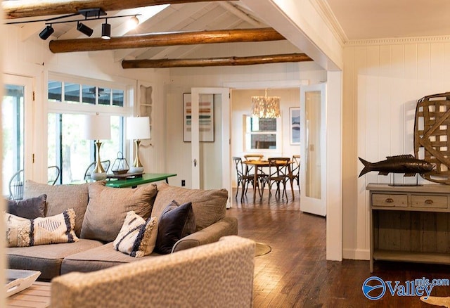 living room with ornamental molding, dark hardwood / wood-style floors, a chandelier, and beam ceiling