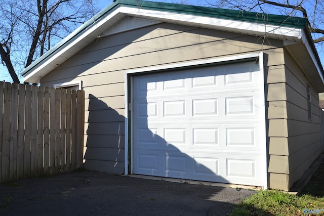 detached garage featuring fence