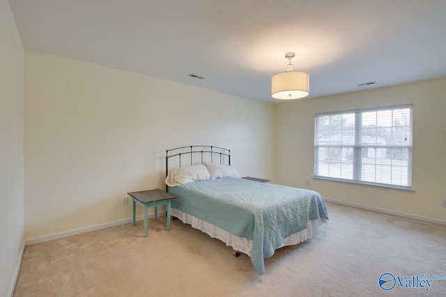 bedroom featuring light carpet, baseboards, and visible vents