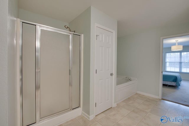 bathroom featuring a garden tub, connected bathroom, a shower stall, and tile patterned floors