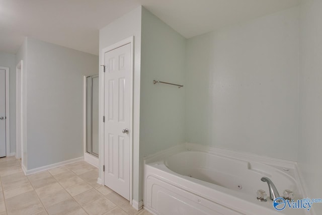 bathroom featuring a whirlpool tub, a shower stall, baseboards, and tile patterned floors