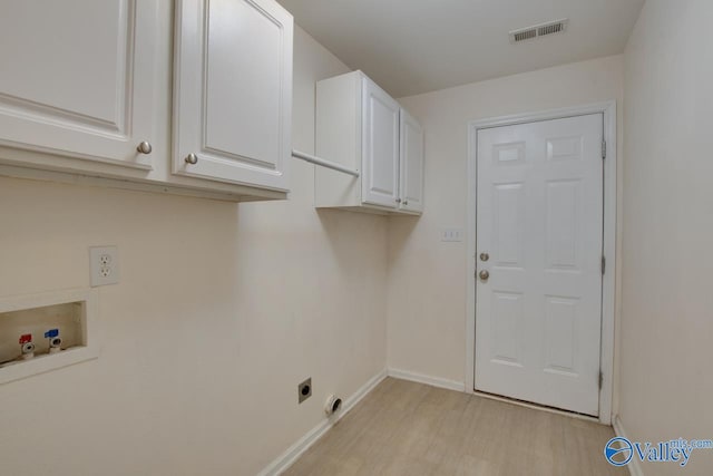 washroom featuring hookup for a washing machine, visible vents, cabinet space, electric dryer hookup, and light wood-type flooring