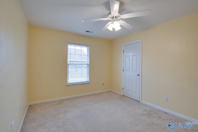 empty room with a ceiling fan, baseboards, visible vents, and carpet flooring