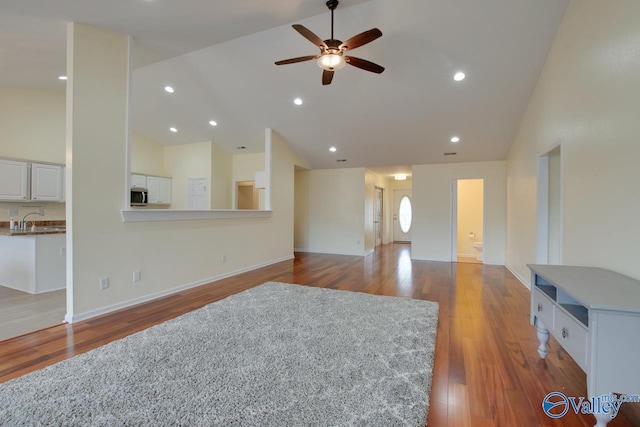 living area featuring ceiling fan, high vaulted ceiling, wood finished floors, and recessed lighting