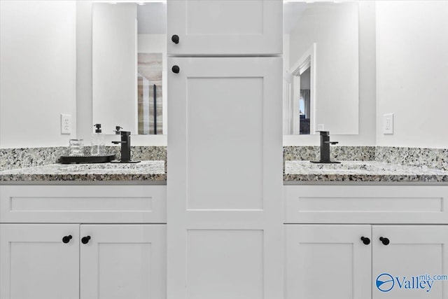 full bathroom with a sink and two vanities
