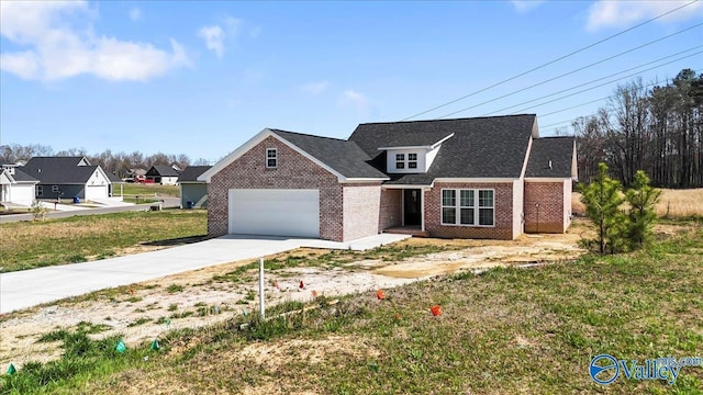traditional home with brick siding, a front yard, driveway, and an attached garage