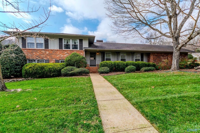 tri-level home with a front lawn