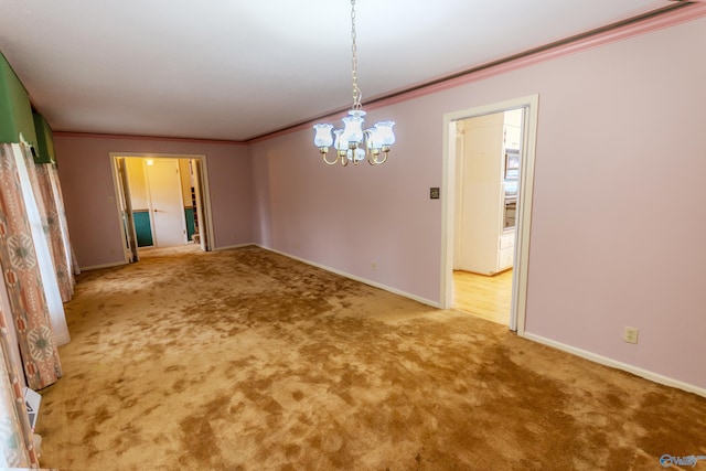 unfurnished dining area featuring carpet flooring, crown molding, and a chandelier